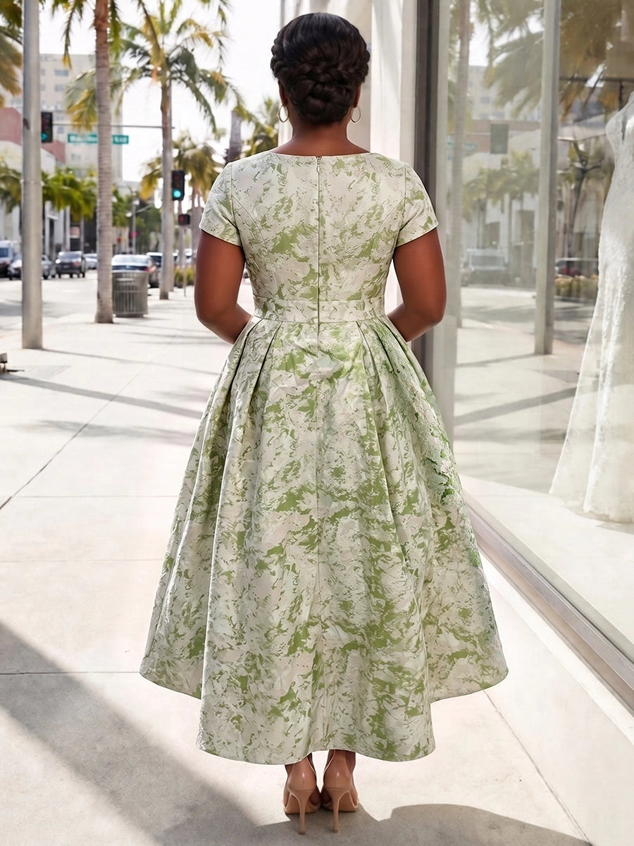 Sage green plus size formal midi dress back view, bateau neck, short sleeves, center back zipper and pleated high-low A-line skirt