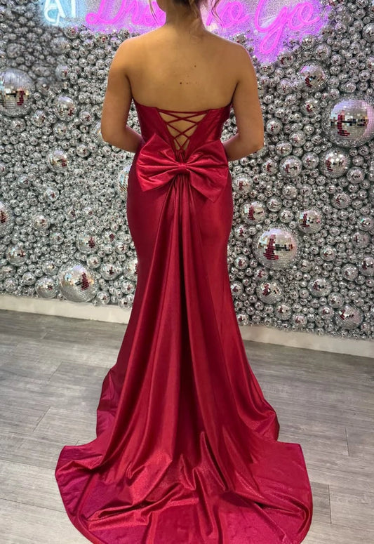 Plus size red satin evening dress with lace-up corset back, large bow and mermaid train