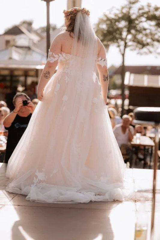Curvy bride wearing Roselledress open‑back plus‑size a‑line lace wedding dress outdoor back view