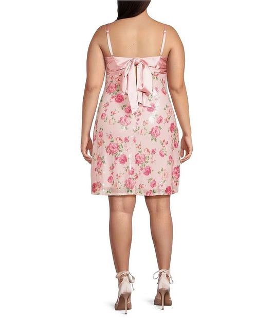 Plus size pink floral homecoming dress featuring satin bow tie back and keyhole cutout