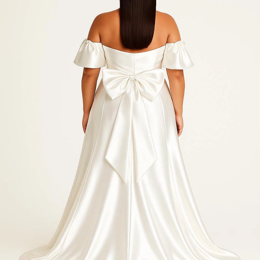 Ivory plus size off-shoulder wedding dress with oversized satin-look bow at the back, fitted bodice and flowing floor-length skirt
