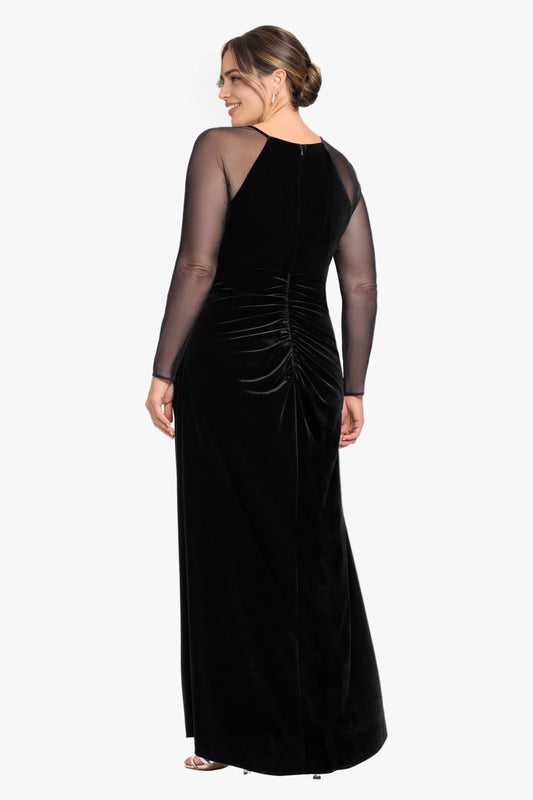 Back view of black plus size velvet wedding guest dress featuring sheer mesh sleeves, center zipper, ruched waist and floor-length skirt by roselledress