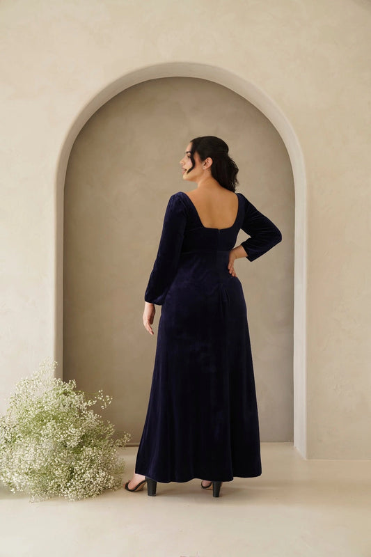 Back view of navy blue plus size velvet evening dress featuring a scoop back, center zipper and flowing maxi skirt by roselledress