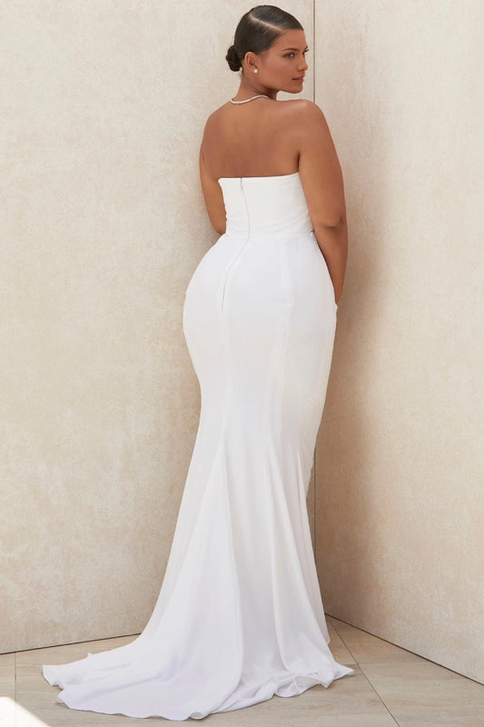 White plus size strapless wedding dress with straight back neckline, center zipper closure, fitted mermaid silhouette and sweeping train
