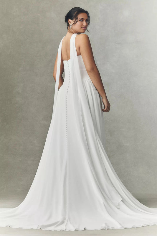 White plus size wedding dress with strapless button-detail back, long flowing scarf panels, soft A-line skirt and elegant sweeping train