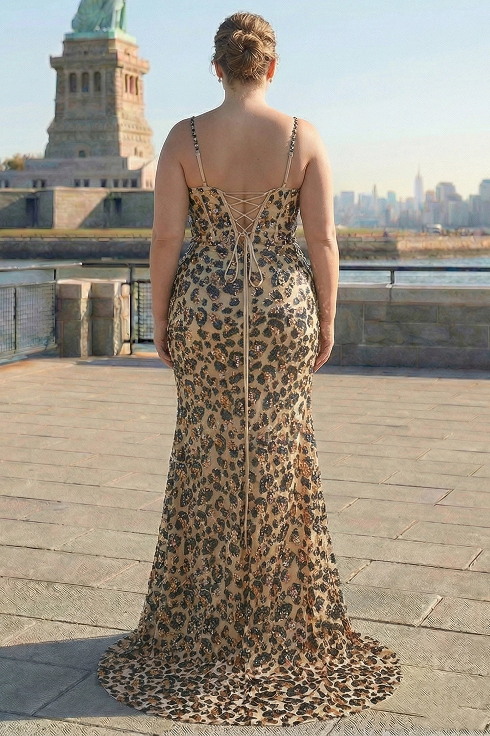 Back view of champagne gold plus size mermaid prom dress featuring a lace-up corset back, sparkling embellishments and sweep train.