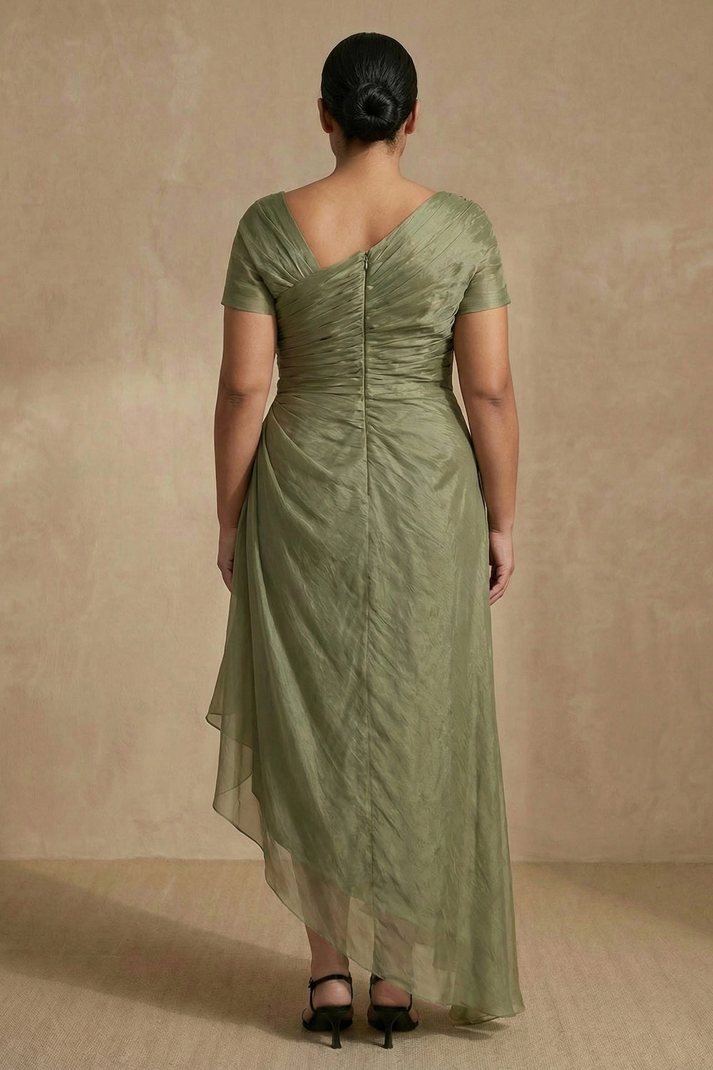Sage green mother of the bride dress with V-back, center zipper and flowing high-low skirt