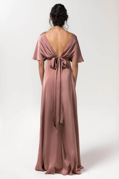 Back view of Roselledress dusty rose bridesmaid dress with a deep V back, statement bow, long ribbon tails and flutter sleeves.