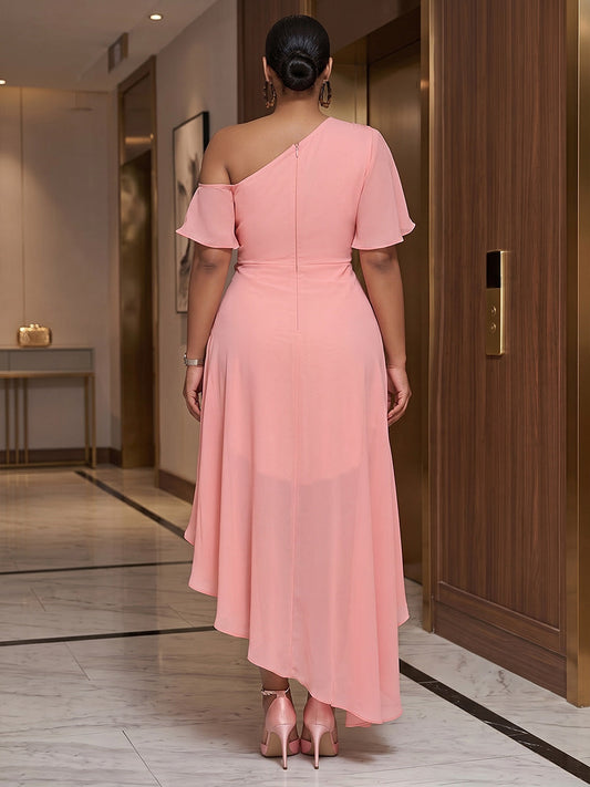 Model wearing roselledress blush chiffon hi‑low wedding guest dress invisible zip back one‑shoulder rear view