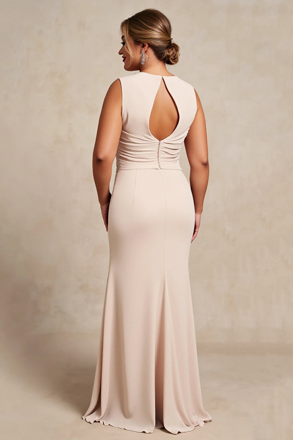 Champagne plus size sleeveless wedding guest gown back view, oval keyhole cutout, ruched waist with covered buttons and floor length mermaid skirt
