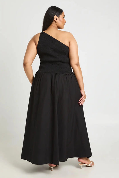 Back view of roselledress black smocked back plus size one‑shoulder flowy maxi formal guest dress