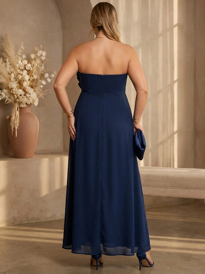 Navy plus size evening gown back view, strapless neckline, center back zipper, empire waist and flowing chiffon maxi skirt
