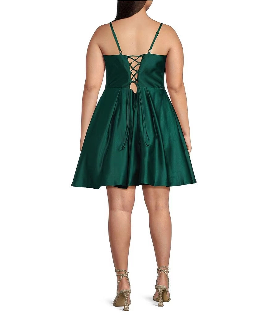 Plus size emerald green satin homecoming dress featuring crisscross lace-up back and keyhole detail
