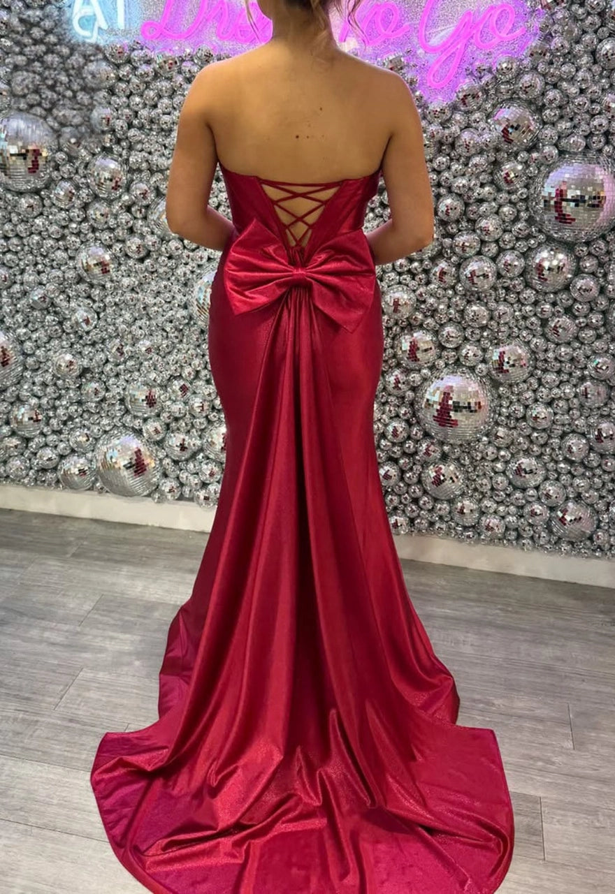 Plus size red satin evening dress with lace-up corset back, large bow and mermaid train
