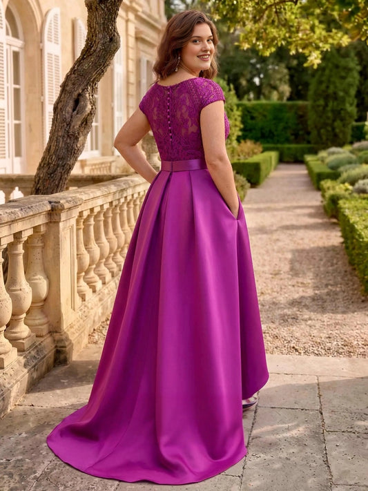 Magenta plus size formal gown back view, lace bodice with button back, cap sleeves, satin waistband and high-low A-line skirt
