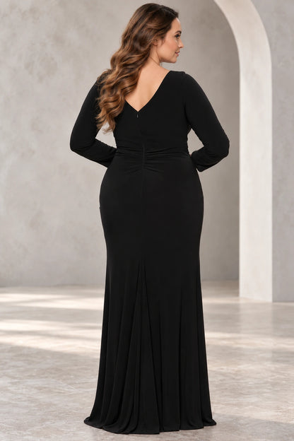 Back view of a black floor-length wedding guest dress with long sleeves, a V-shaped back, center zipper and gathered waist.