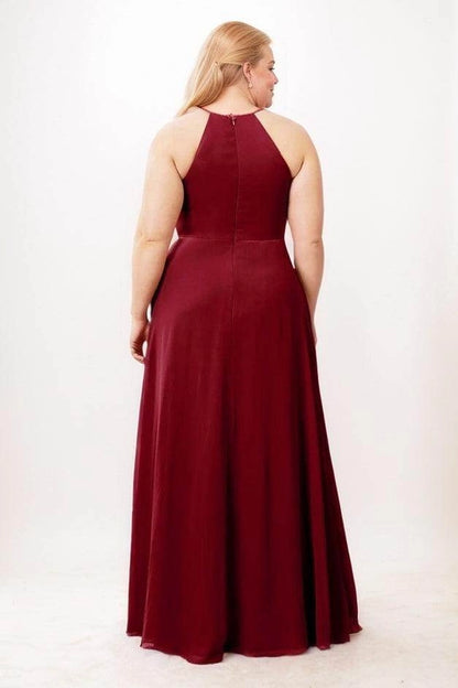 Burgundy velvet bridesmaid dress with a high back panel, exposed shoulders, center-back zipper and floor-length A-line skirt, back view.