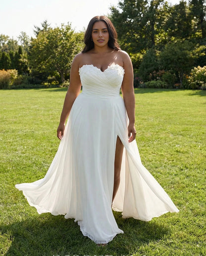 Ivory plus size A-line wedding dress with a sweetheart strapless neckline, floral embellishments, high slit and flowing skirt.