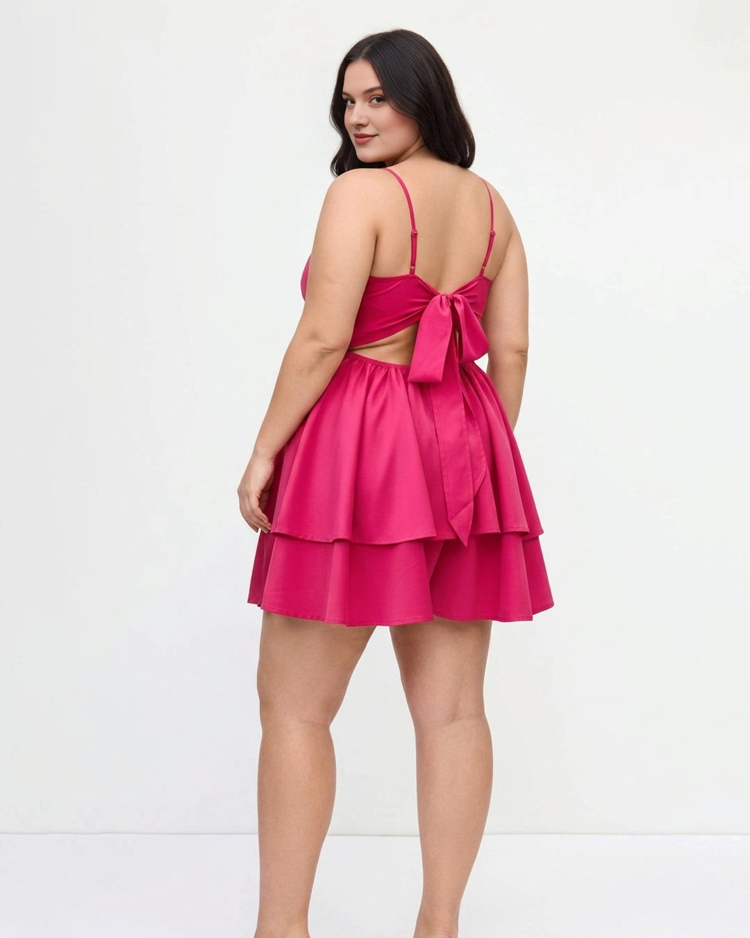 Plus size hot pink homecoming dress featuring bow tie back, cutout and tiered skirt
