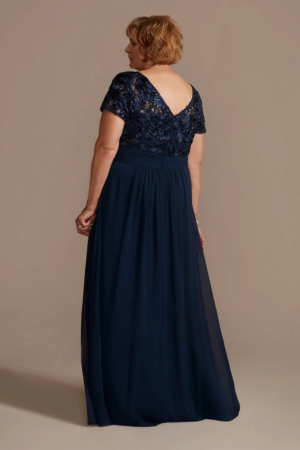 Navy blue lace mother of the bride dress with V-back and flowing maxi skirt