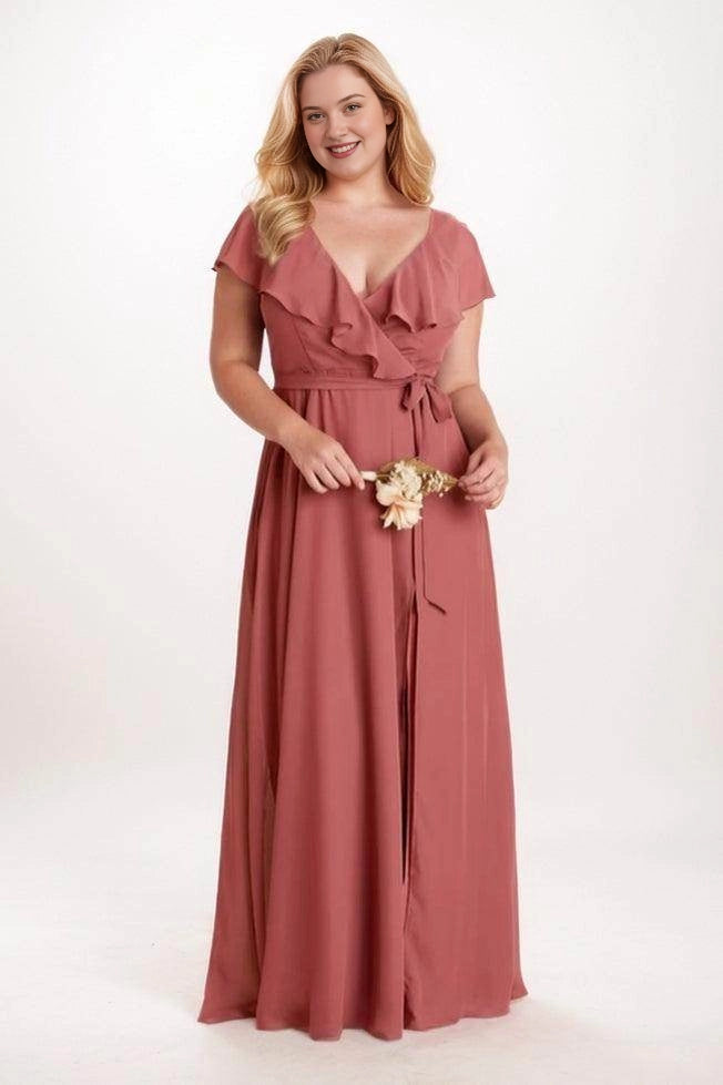 Roselledress dusty rose plus size bridesmaid dress with a ruffled V neckline, flutter sleeves, waist tie and long A-line skirt.