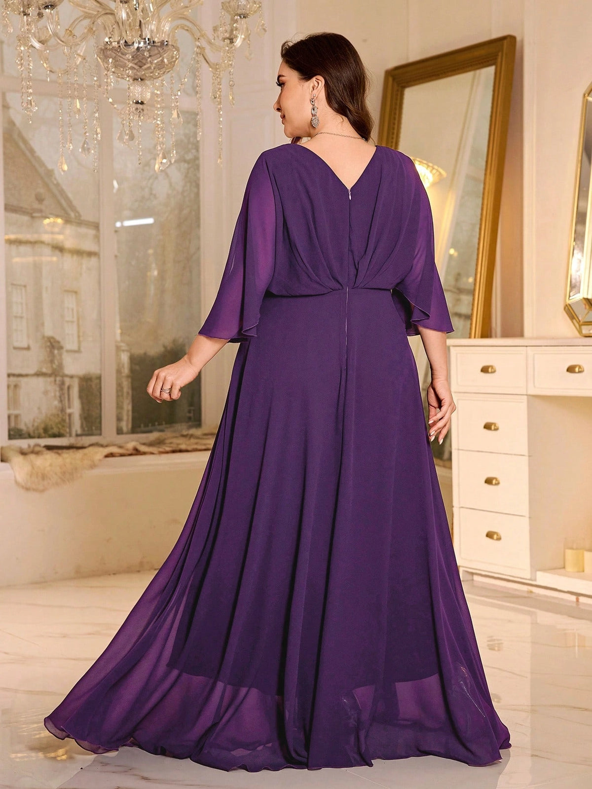 Purple mother of the bride dress with V-back, flutter sleeves and flowing maxi skirt