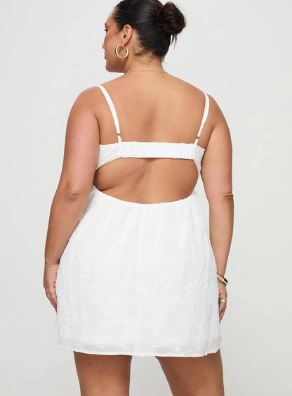 Plus size white chiffon homecoming dress featuring open back cutout and thin straps
