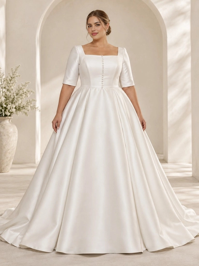 Ivory plus size satin wedding dress with square neckline, short sleeves, decorative front buttons and full A-line skirt.