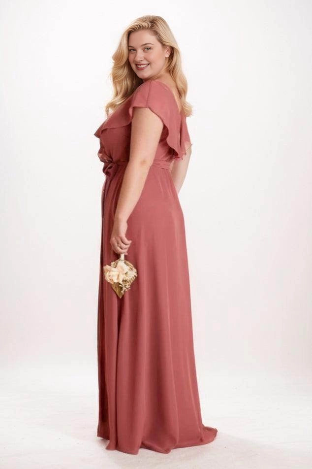 Side back view of Roselledress dusty rose bridesmaid dress with a covered back, draped shoulder overlay and flowing skirt.