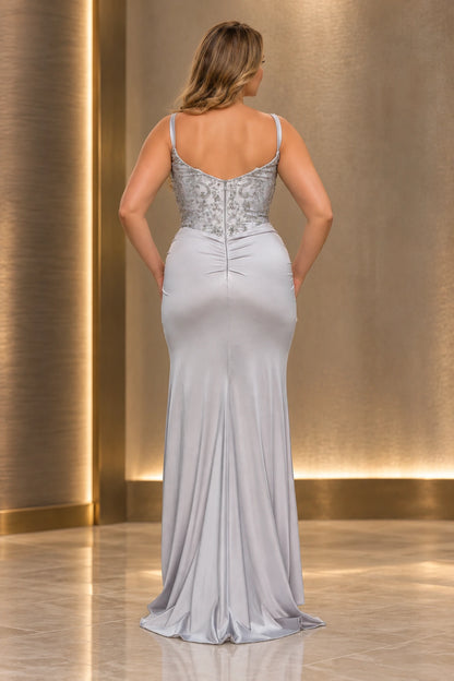 Back view of a silver satin prom dress with a beaded scoop-back bodice, center zipper, gathered waist and a softly trailing hem.