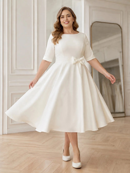 Ivory plus size A-line midi wedding dress with boat neckline, short sleeves and decorative bow waist.