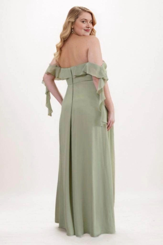 Sage green bridesmaid dress with a low straight back, ruffle trim, cascading sleeve tails and a center-back zipper, back view.