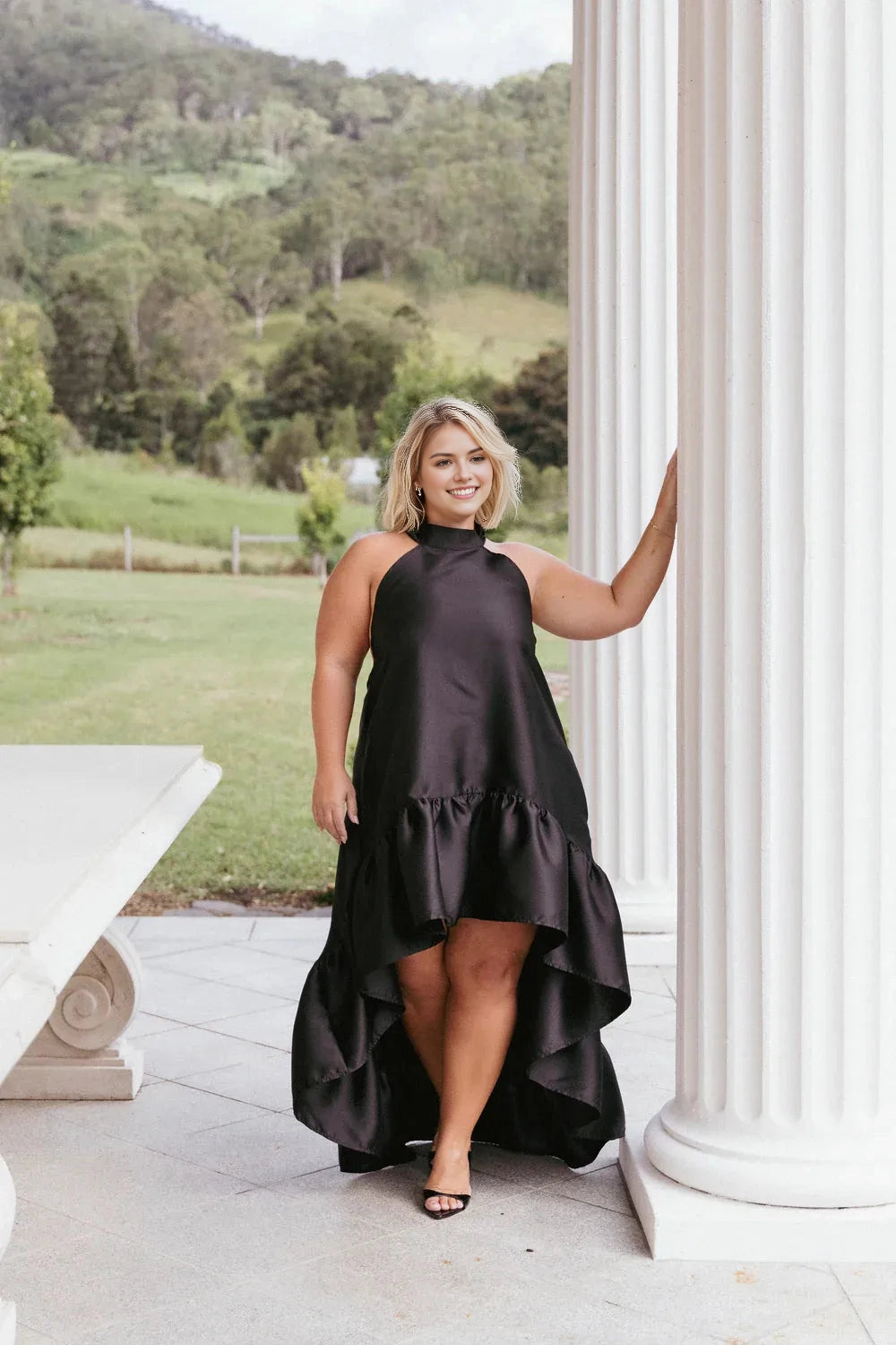 Roselledress black satin plus size wedding guest dress front view,halter neck sleeveless high‑low ruffle formal gown