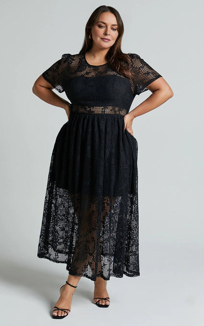 Roselledress black floral lace plus size wedding guest midi dress front view, round neck short sleeve gown with waist sheer cutout