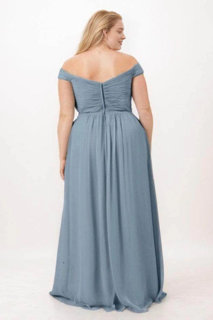 Back view of Roselledress dusty blue bridesmaid dress with draped sleeves, a shallow V back, gathered bodice and center zipper.