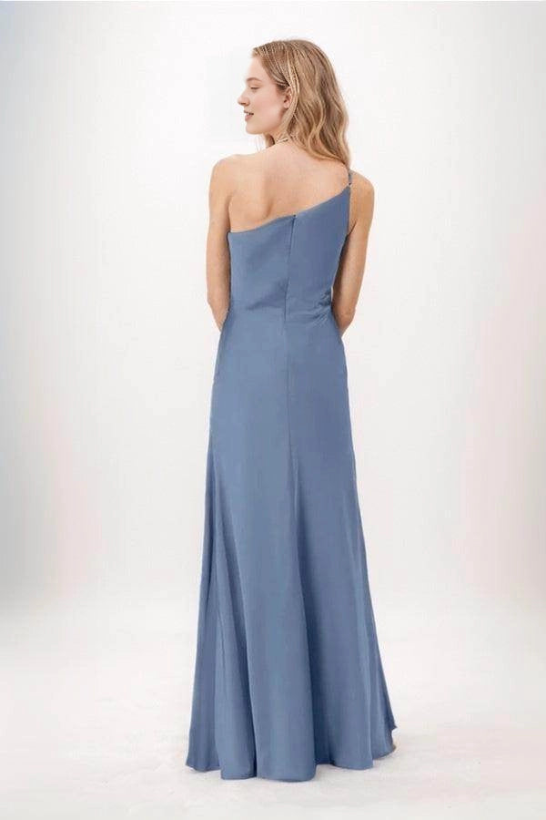 Back view of a Roselledress dusty blue bridesmaid dress with an asymmetric one-shoulder neckline, center-back zipper and gently flared long skirt.