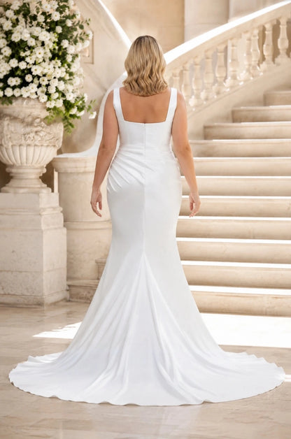 Back view of a white plus size satin wedding dress with wide straps, square back, center zipper and long train.