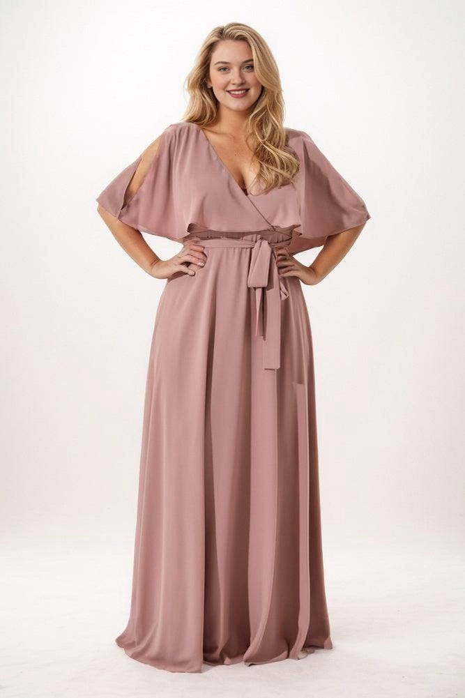 Dusty rose chiffon bridesmaid dress with a crossover V-neck, cape sleeves, shoulder cutouts and a front waist tie, front view.