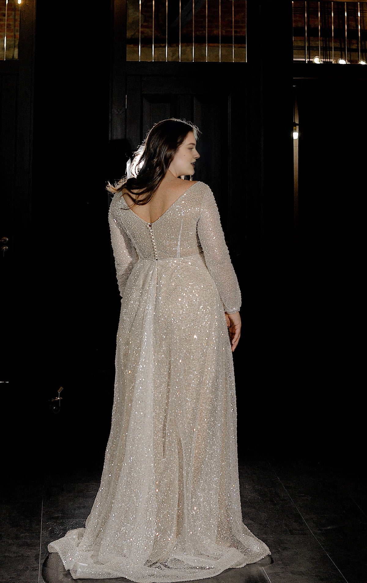 Ivory plus size wedding dress with off-shoulder sleeves, covered button back, fitted mermaid silhouette and flowing sweep train