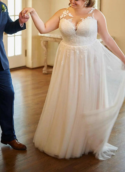 Ivory plus size A-line wedding dress with illusion sweetheart neckline, floral lace bodice, sheer shoulder details and flowing tulle skirt