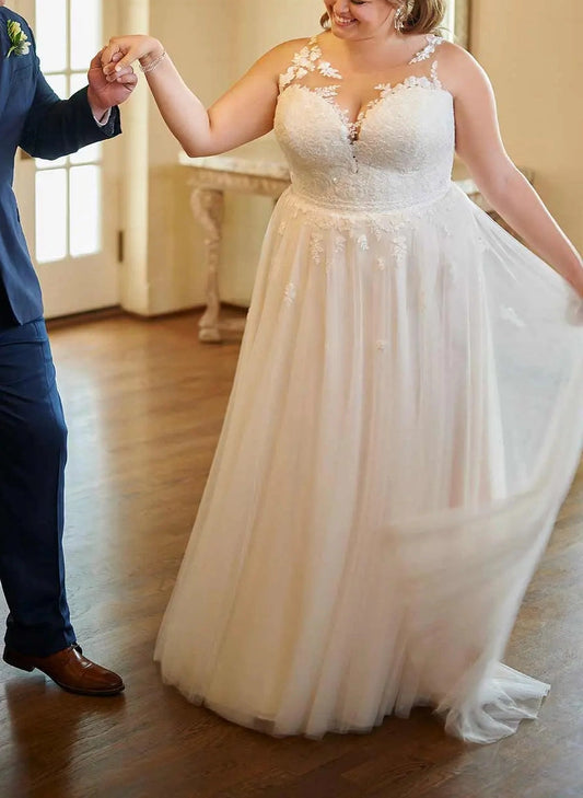 Ivory plus size A-line wedding dress with illusion sweetheart neckline, floral lace bodice, sheer shoulder details and flowing tulle skirt