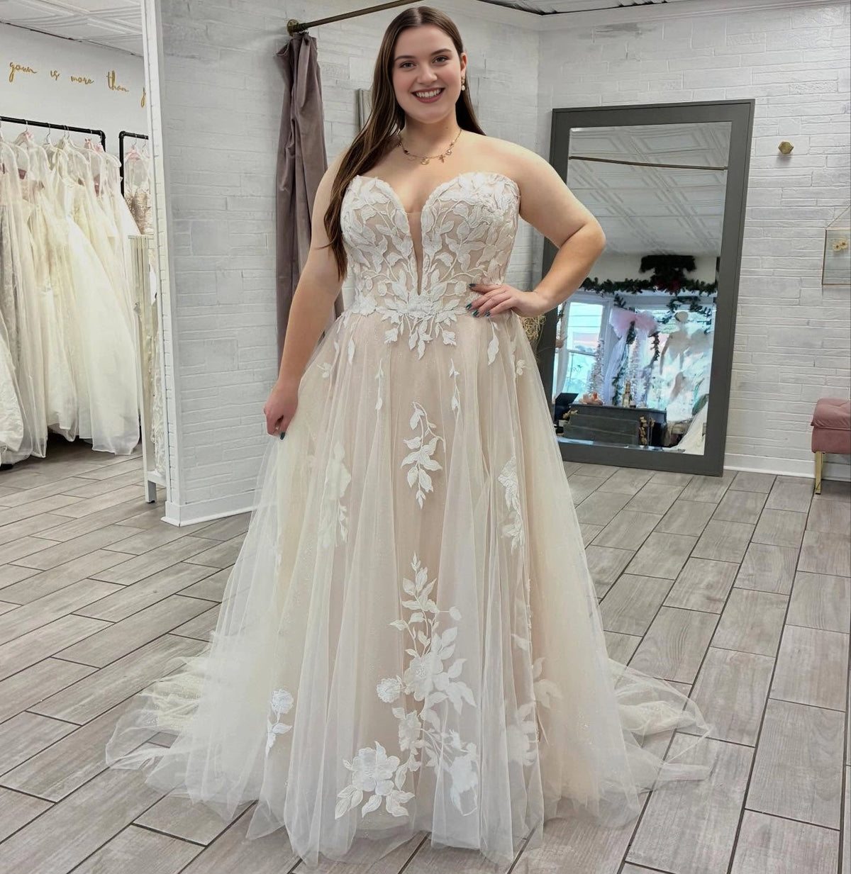 Ivory plus size A-line wedding dress with plunging V-neck, strapless floral lace corset bodice and flowing tulle skirt