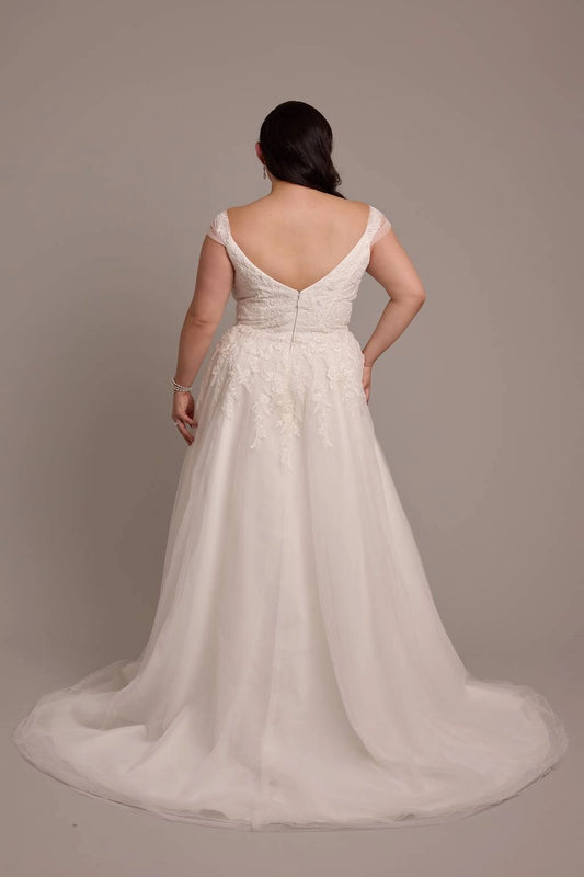 Ivory plus size wedding dress with low V-back, center zipper, floral lace appliques and flowing tulle sweep train