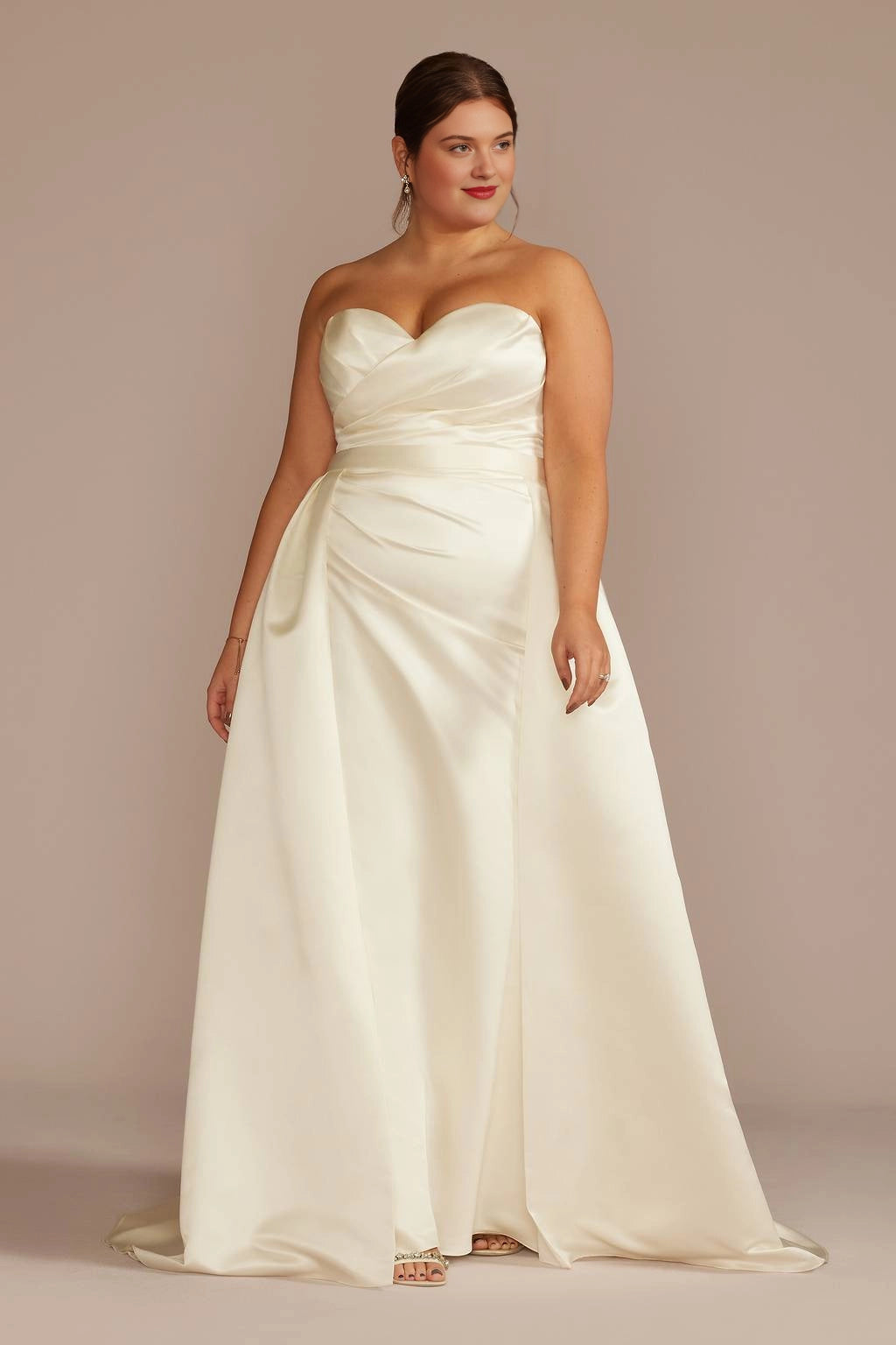Ivory plus size A-line wedding dress with strapless sweetheart neckline, ruched satin-look bodice, defined waist and flowing floor-length skirt
