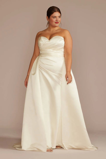 Ivory plus size A-line wedding dress with strapless sweetheart neckline, ruched satin-look bodice, defined waist and flowing floor-length skirt