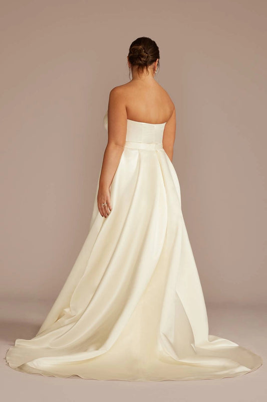 Ivory plus size strapless wedding dress with straight back neckline, fitted waist, pleated A-line skirt and elegant sweeping train