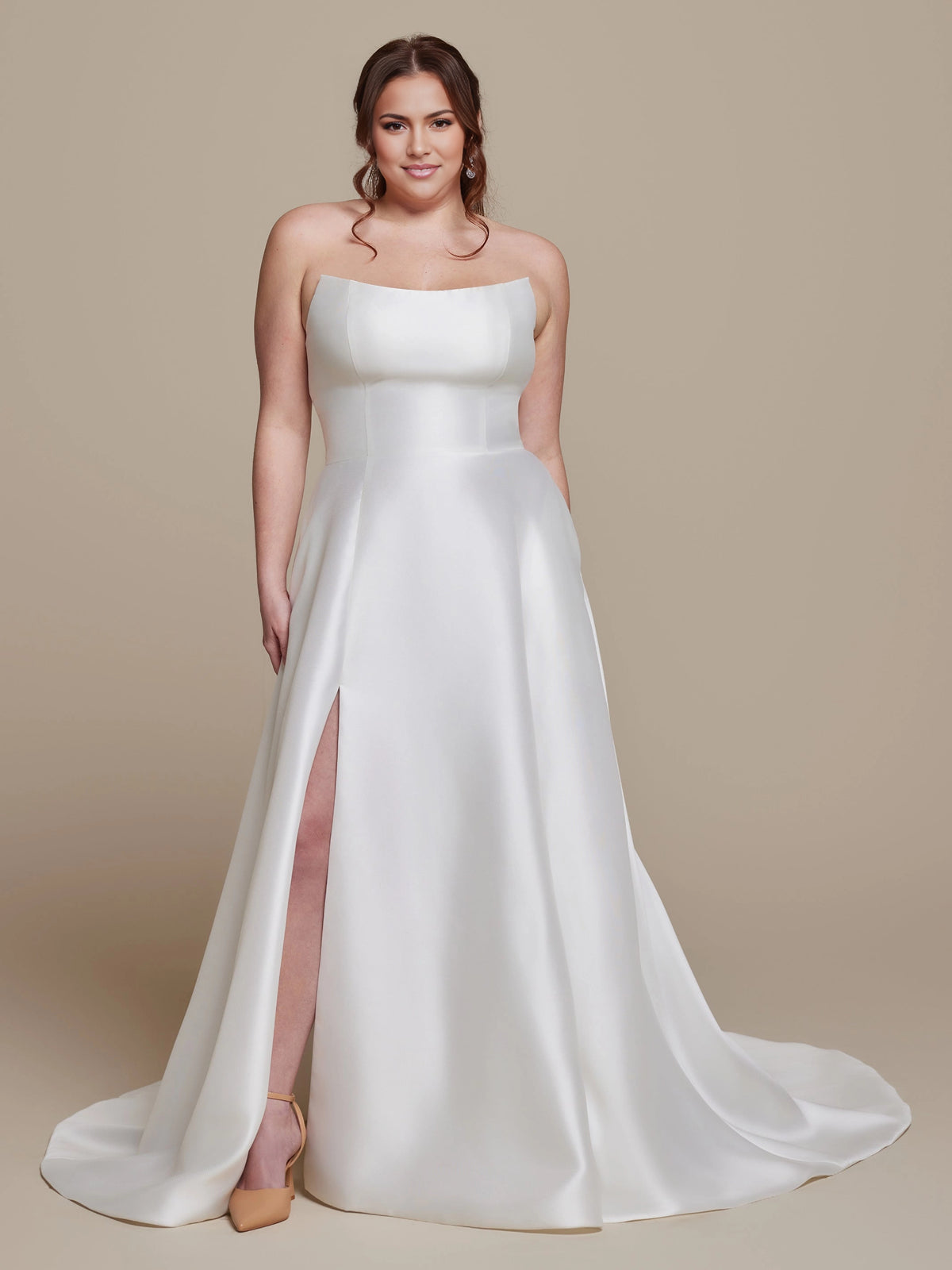 Ivory plus size A-line wedding dress with strapless curved neckline, fitted bodice, front thigh-high slit and flowing satin-look skirt