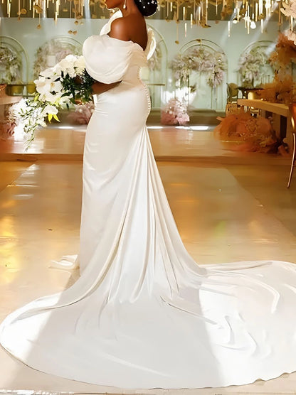Back view of off shoulder mermaid wedding dress featuring elegant draped sleeves, fitted waist and long chapel train.