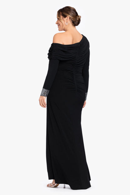 Back view of black plus size wedding guest dress featuring asymmetric draped neckline, ruched back, center zipper and floor-length skirt by roselledress