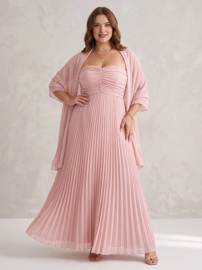 Plus size blush pink pleated chiffon mother of the bride dress with strapless bodice, matching sheer shawl and floor length skirt, front view
